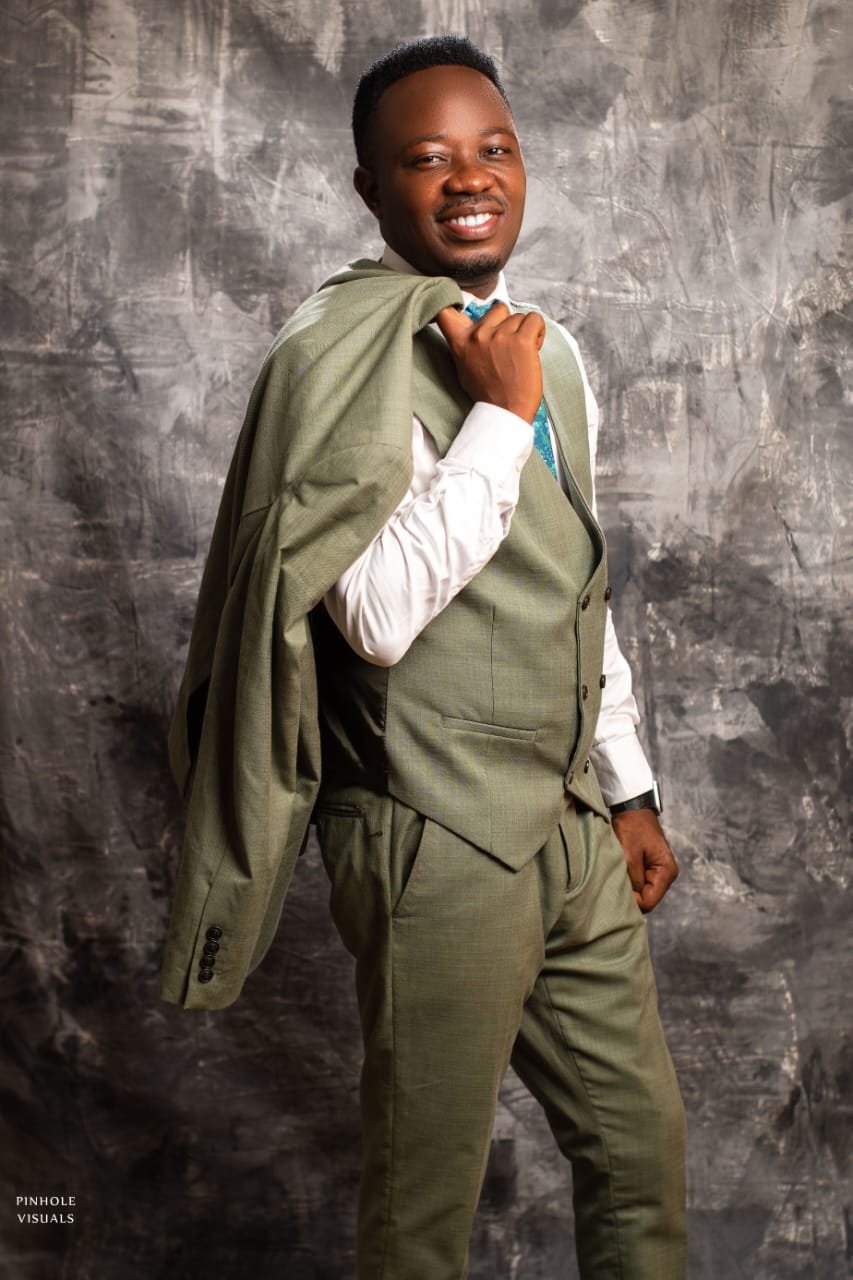 Pastor Cylars smiling in a sage suit